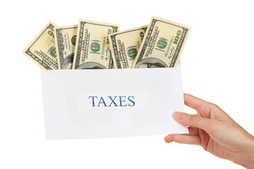 Woman's hand holding an envelope with money on white background