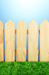 Fototapeta premium A wooden fence on a blue background close-up