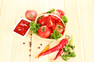 Still life tomatoes ketchup and herbs on wooden table