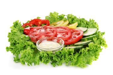 Chopped vegetables and sauce on plate isolated on white