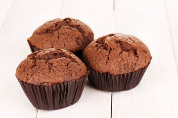 Fresh muffins on wooden background