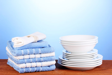 kitchen towels with dishes on blue background close-up