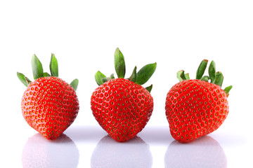 three strawberries on white background
