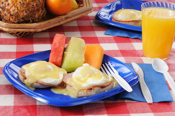 Eggs Benedict with fresh melon slices