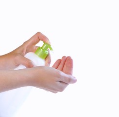 Hands with a bottle moisturizer for the body.