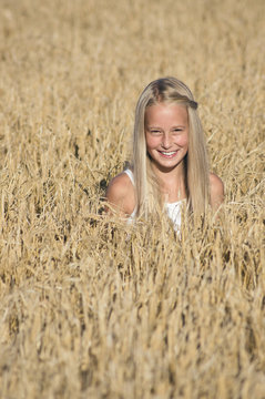 Blond Girl sitting in a field