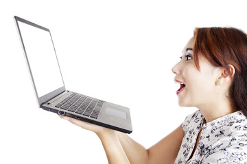 Amazed woman holding a laptop