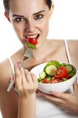 young girl eating vegetables