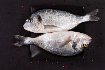 Luxurious fish on black plate.