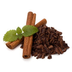 Crushed chocolate shavings pile and cinnamon sticks