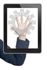 Hand pushing gear icon tablet on a touch screen blank interface