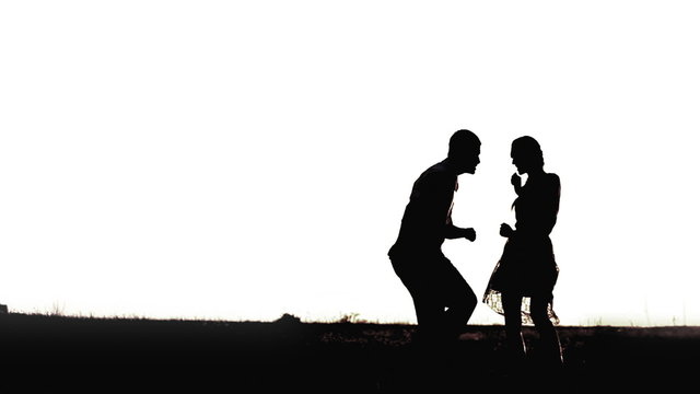 Young black couple silhouettes dancing isolated on white