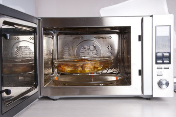 Chicken legs on a glass dish in the convection oven