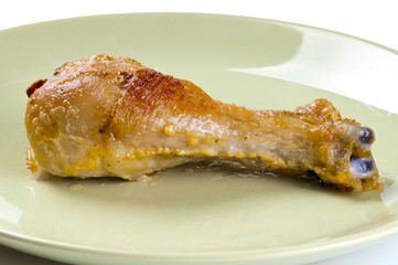 Chicken leg on a green plate