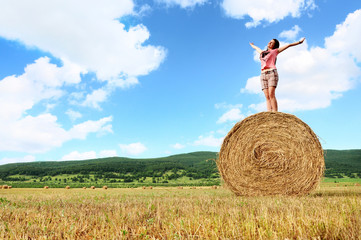 Naklejka na ściany i meble Woman enjoying on the wheat