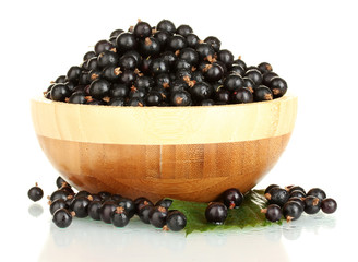 Fresh black currant in wooden bowl isolated on white