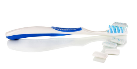 Chewing gum and toothbrush isolated on white