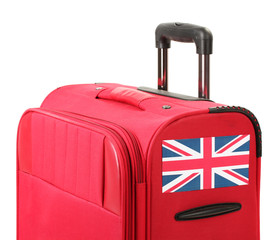 red suitcase with sticker with flag of United Kingdom isolated