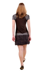 back view of walking woman .