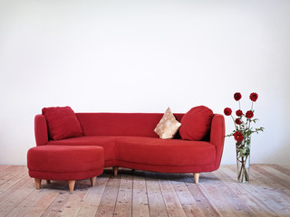 red sofa and vase with red dahlia