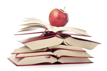 Red apple on the pile of books on white background