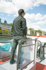 Boating in Lugano - Man driving a boat on a lake in Lugano, Swit