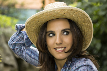 Pretty sexy woman face with a straw hat