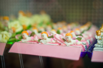 Baby with book candies under shopping window in mall