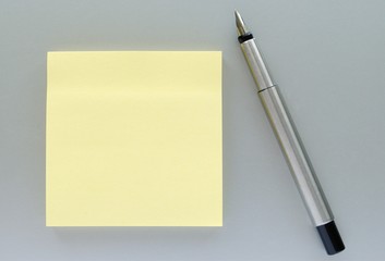 yellow sheet reminders and pen on the table