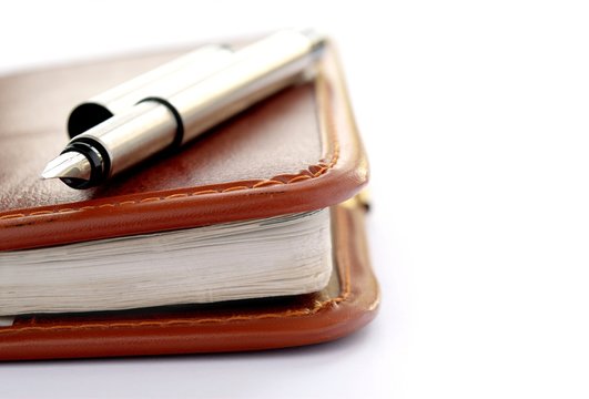 Check Book And A Fountain Pen On A White Background