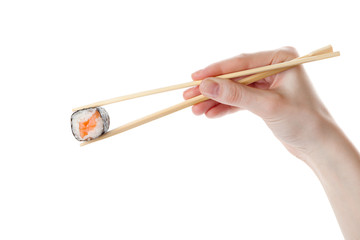 Hand holds the sushi with chopsticks, isolated on white