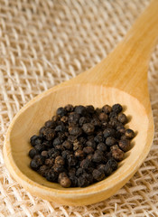Pepper in a wooden spoon over straw
