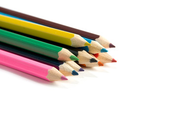 Color pencils over white background