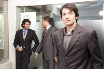 close up of  asian businessman with colleagues in background