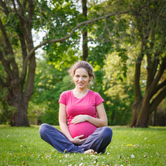 Beautiful pregnant woman in the park