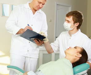 Young woman with dentist in a dental surgery. 