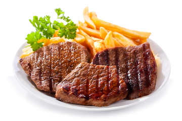 plate of grilled meat with frieis
