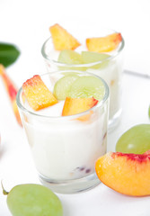 Fresh peach and grape yogurt in glass 