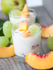 Fresh peach and grape yogurt in glass 