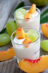Fresh peach and grape yogurt in glass 