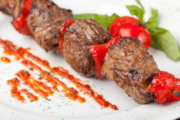 Grilled meat on a white plate