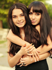 Portrait of young beautiful sisters outdoor