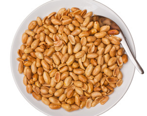 Plate of salted fried peanuts, isolated on white background