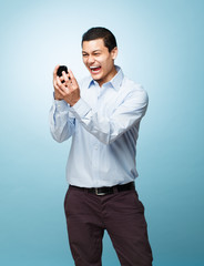 Happy young man holding mobile phone
