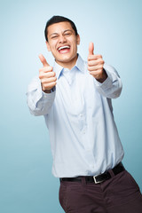 Happy young man giving thumbs up sign