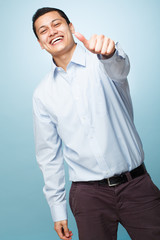 Happy young man giving thumbs up sign