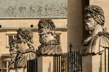 Four stone heads outside the Sheldonian theatre Oxford