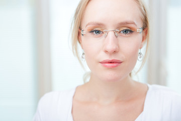 Closeup portrait of a intelligent young woman wearing glasses