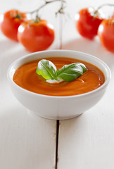 tomato soup with basil garnish and copyspace composition