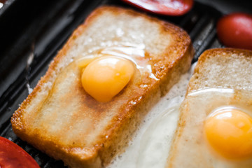 Frying pan with eggs and bacon